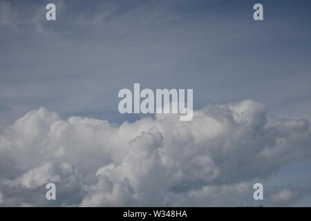 White cummulus  clouds on a bright blue sky  summers day Stock Photo