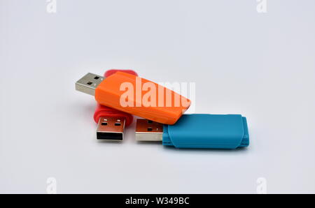 USB flash memory drives with colours, orange, blue and red, on a white background. Stock Photo