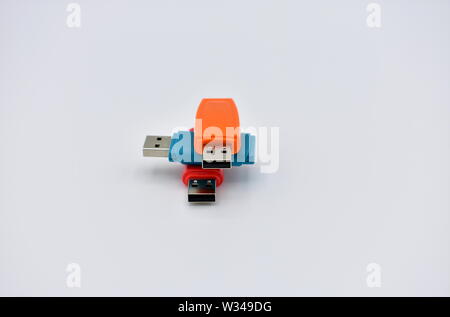 USB flash memory drives with colours, orange, blue and red, on a white background. Stock Photo