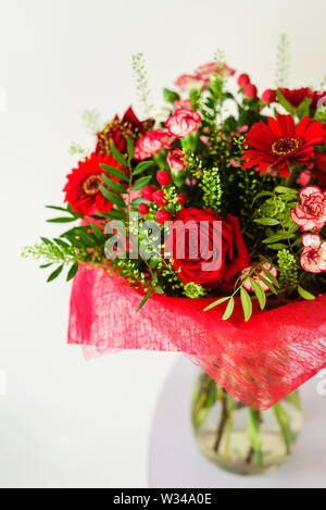 Bouquet of colorful roses in glass vase isolated on white Stock Photo ...