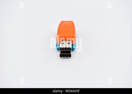 USB flash memory drives with colours, orange, blue and red, on a white background. Stock Photo