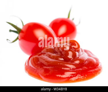 Tomato ketchup with tomatoes isolated on white background Stock Photo