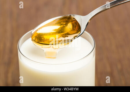 Honey milk isolated on brown background Stock Photo