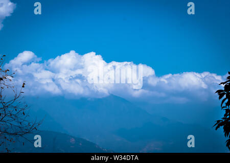 Background photo of Cloudy overcast morning at himalayan mountains. Dreamy landscape. Fluffy weather. Beauty of wild east asian indian nature. Magnifi Stock Photo