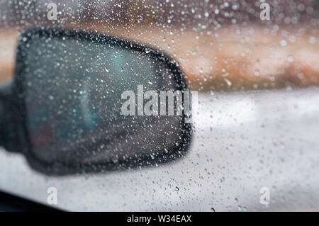 rain drops on the side mirror of the car, water drops on the mirror Stock Photo