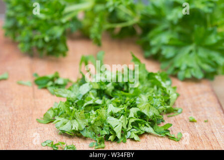 chopped parsley leaves on cutting board  closeup Stock Photo