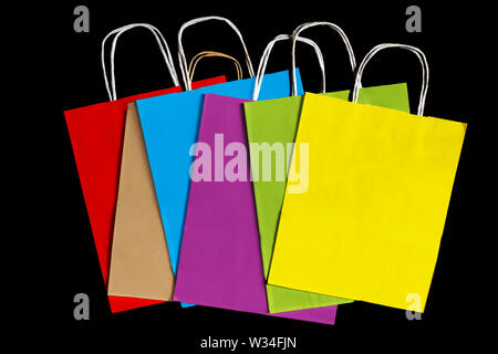 Colored paper bags on a black background. Ecological concept. Stock Photo