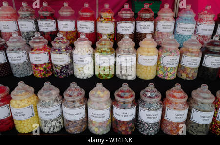 Jars of sweets on a market stall Stock Photo