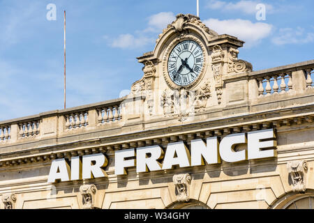 The Air France sign is affixed to the facade of the Invalides air terminal, a former railway station in Paris, France. Stock Photo