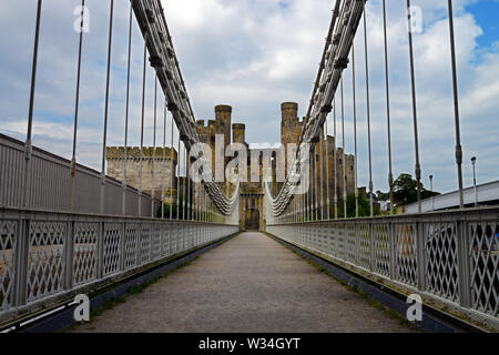 Conwy Suspension Bridge is a Grade I-listed structure built by Thomas Telford in 1822–26. It was designed to match the adjacent Conwy Castle. Stock Photo