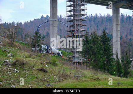 Slovenia: Crew of workers working on repair and maintenance of the substructure on an elevated highway.  Pylons are surrounded by scaffolding Stock Photo