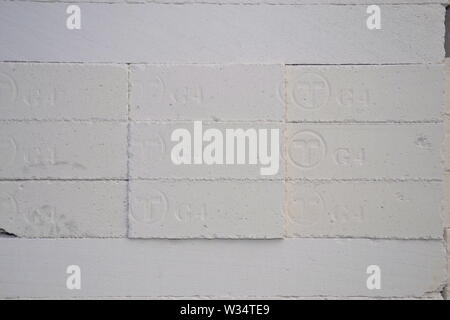 A neat pile of white bricks waiting to be used at a building site Stock Photo