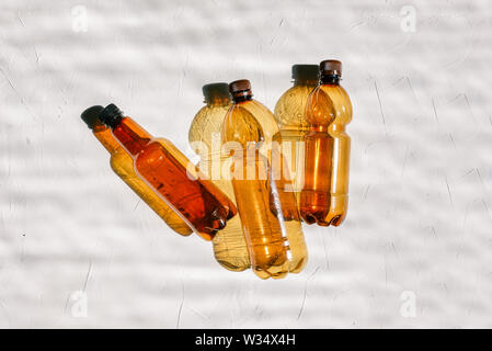 Plastic bottles for recycling. Bright light from the sun and the shadow of the bottle. Recycling and recycling. Ecology gaps Stock Photo