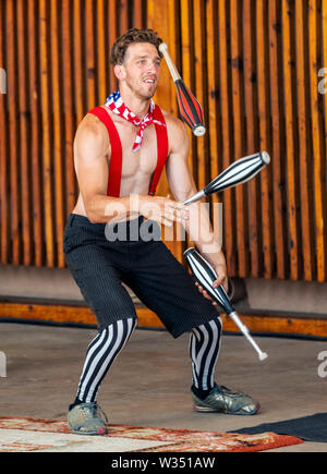 Male juggler performing at Fourth of July event; Salida Circus; Salida; Colorado; USA Stock Photo