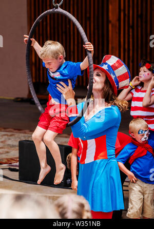 Young boy performing on circus rings hoops Lyras; Fourth of July event; Salida Circus; Salida; Colorado; USA Stock Photo