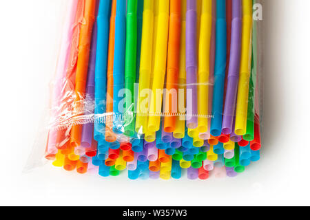 Pile of colorful plastic drinking straws in plastic wrapping. Close up image. Stock Photo