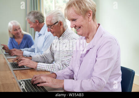 Teacher With Senior Students In Computing Adult Education Class Stock Photo