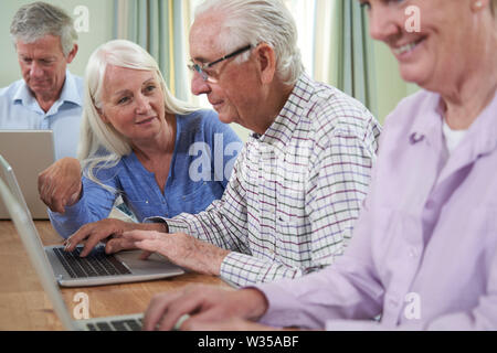 Teacher With Senior Students In Computing Adult Education Class Stock Photo