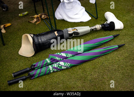 General view of a prosthetic leg and umbrellas on day eleven of the Wimbledon Championships at the All England Lawn Tennis and Croquet Club, London. Stock Photo