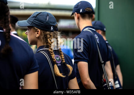 General view of ballboys and ballgirls on day eleven of the Wimbledon Championships at the All England Lawn tennis and Croquet Club, London. Stock Photo