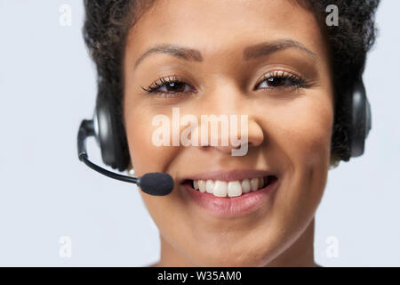 Portrait Of Businesswoman Wearing Telephone Headset In Customer Services Department Stock Photo