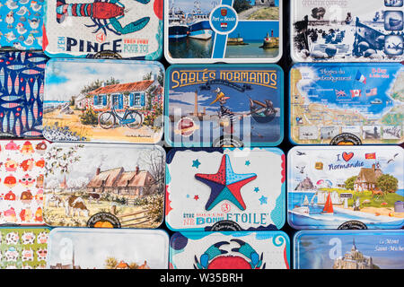 Metal boxes with sablés, French round shortbread cookies as souvenirs on display in souvenir shop at seaside resort Port-en-Bessin, Normandy, France Stock Photo