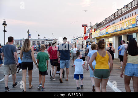 OCEAN CITY, NEW JERSEY/USA - JUNE 27, 2019: Tourists enjoying the famous boardwalk in Ocean City New Jersey at dusk Stock Photo