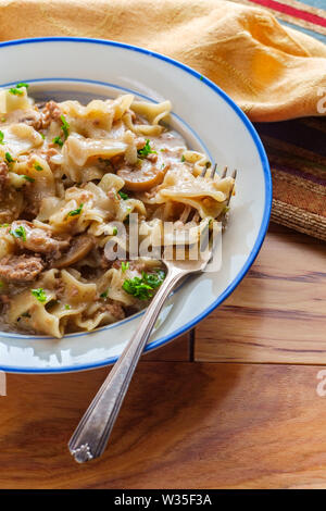 Creamy beef and mushroom stroganoff with egg noodles Stock Photo