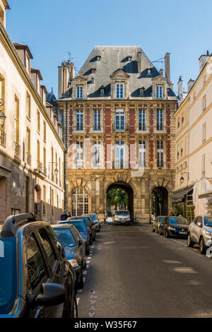 Rue de birague paris with entrance arches to Place des Vosges, Paris France Stock Photo