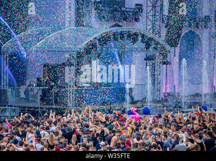 Neustadt Glewe, Germany. 12th July, 2019. Visitors dance at the Electro-Festival 'Airbeat One' in front of the grandstand. The festival is one of the largest electronic music festivals in Northern Germany and, according to the organizers, had 180,000 visitors over several days last year. Credit: Jens Büttner/dpa-Zentralbild/dpa/Alamy Live News Stock Photo