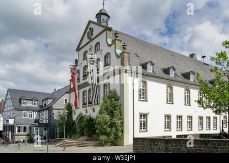 Brilon, North Rhine Westphalia / Germany - June 23th 2018: Brilon city hall decorated with flags. Lateral view. It is celebrated shooting match. Stock Photo
