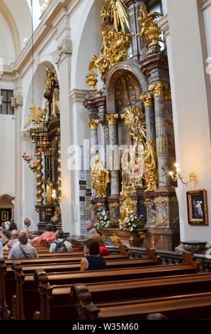 Prague, Czech Republic - June 27 2019: Tourists admiring the Infant Jesus of Prague in the Discalced Carmelite Church of Our Lady Victorious. Religious landmark, Roman Catholic, faith concept. Stock Photo