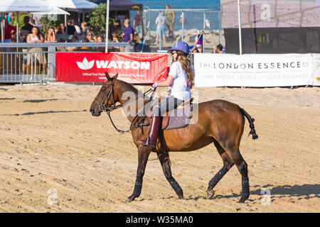 Sandbanks, Poole, Dorset, UK 12th July 2019. The Sandpolo British Beach Polo Championships gets underway at Sandbanks beach, Poole on a warm sunny day. The largest beach polo event in the world, the two day event takes place on Friday and Saturday, as visitors head to the beach to see the action. Actress and EastEnders star Rita Simons takes part in a penalty shoot out. Credit: Carolyn Jenkins/Alamy Live News Stock Photo