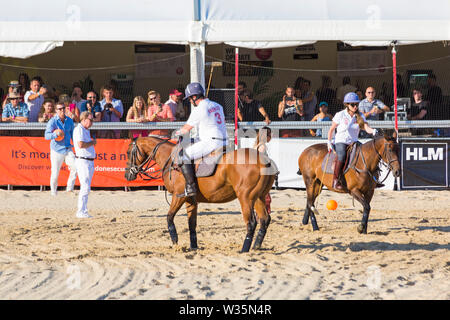 Sandbanks, Poole, Dorset, UK 12th July 2019. The Sandpolo British Beach Polo Championships gets underway at Sandbanks beach, Poole on a warm sunny day. The largest beach polo event in the world, the two day event takes place on Friday and Saturday, as visitors head to the beach to see the action. Actress and EastEnders star Rita Simons takes part in a penalty shoot out against Nick Knowles with Harry Redknapp commentating and overseeing. Credit: Carolyn Jenkins/Alamy Live News Stock Photo