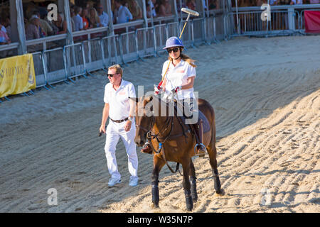 Sandbanks, Poole, Dorset, UK 12th July 2019. The Sandpolo British Beach Polo Championships gets underway at Sandbanks beach, Poole on a warm sunny day. The largest beach polo event in the world, the two day event takes place on Friday and Saturday, as visitors head to the beach to see the action. Actress and EastEnders star Rita Simons takes part in a penalty shoot out with Harry Redknapp commentating and overseeing. Credit: Carolyn Jenkins/Alamy Live News Stock Photo