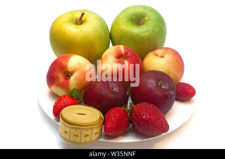 Fresh fruits in a plate isolated on white background Stock Photo