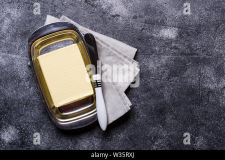Fresh butter and knife in butter-dish Stock Photo