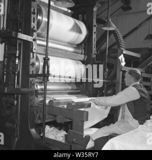 1950s, historical, male worker operating a machine at a linen factory, Northern Ireland, Stock Photo