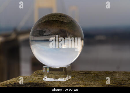 Beautiful morning light on elegant suspension bridge through crystal ball, The Severn Crossing. Stock Photo