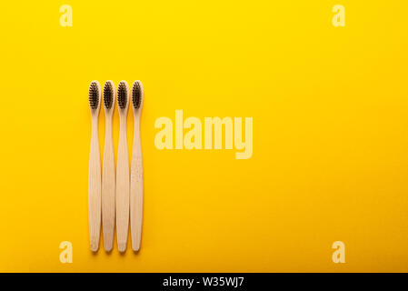 A family set of four wooden bamboo toothbrushes Stock Photo