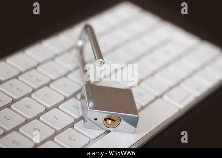Stainless padlock on computer keyboard. PC network security, data security and antivirus protection concept. - Image Stock Photo