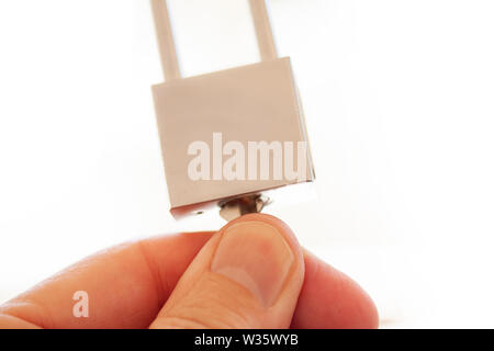 Hands holding, locking and unlocking stainless steel padlock isolated over white background - Image Stock Photo