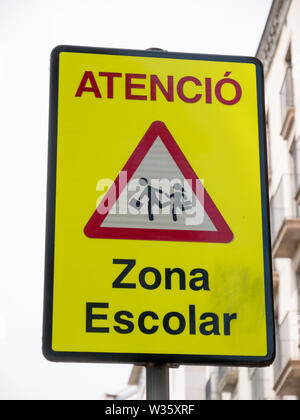 A yellow warning sign 'Zona Escolar' in spanish mean 'School Zone' in English, Barcelona, spain Stock Photo