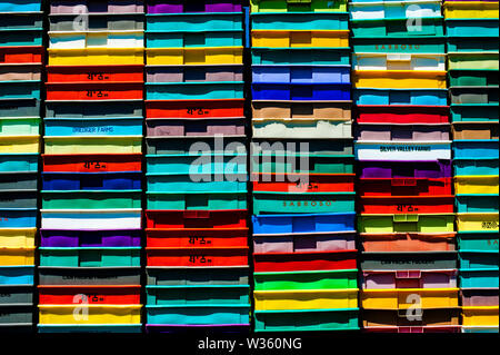 Stack of multicolored plastic crates. Stock Photo