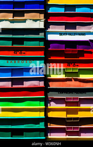 Stack of multicolored plastic crates. Stock Photo