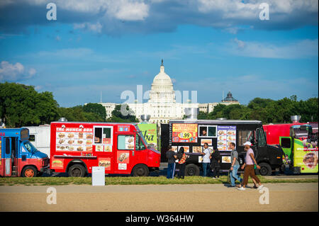 WASHINGTON, DC - AUGUST, 2018: Food trucks selling a variety of international street food line up on The Mall in front of the Capitol Building. Stock Photo