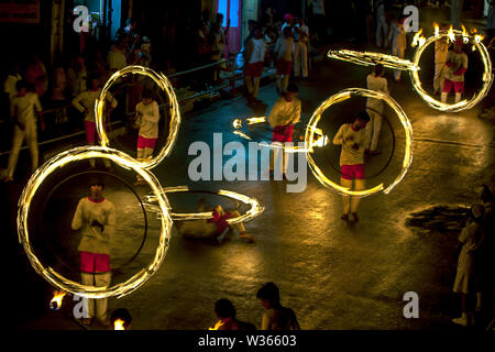A spectacular site as Fire Ball Dancers perform along Colombo Street in Kandy during the Buddhist Esala Perahera (procession) in Sri Lanka. Stock Photo