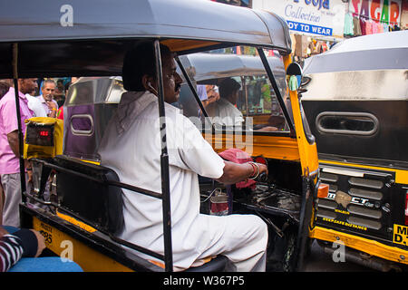 Mumbai, Maharashtra, india - JUNE 4th, 2019 : Indian man driver driving auto-rickshaw taxi - Image Stock Photo