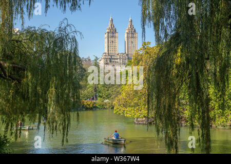 New York City, NY, USA - October 15, 2013: rowing a boat at Central Park lake, in the middle of trees and buildings as background. Stock Photo