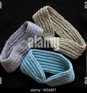 Group of handmade head bands knit in free time as leisure activity at home, accessories for woman from yarn Stock Photo